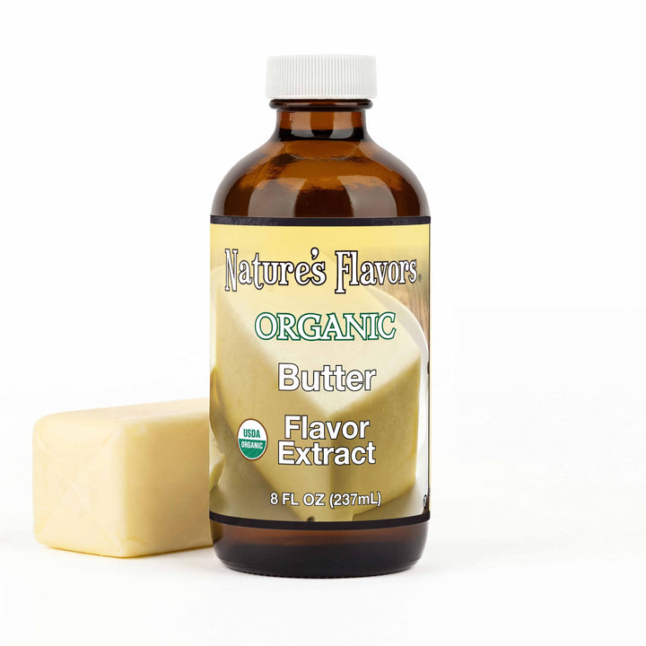 Bottle labeled, "Organic Butter Flavor Extract" next to a stick of butter.