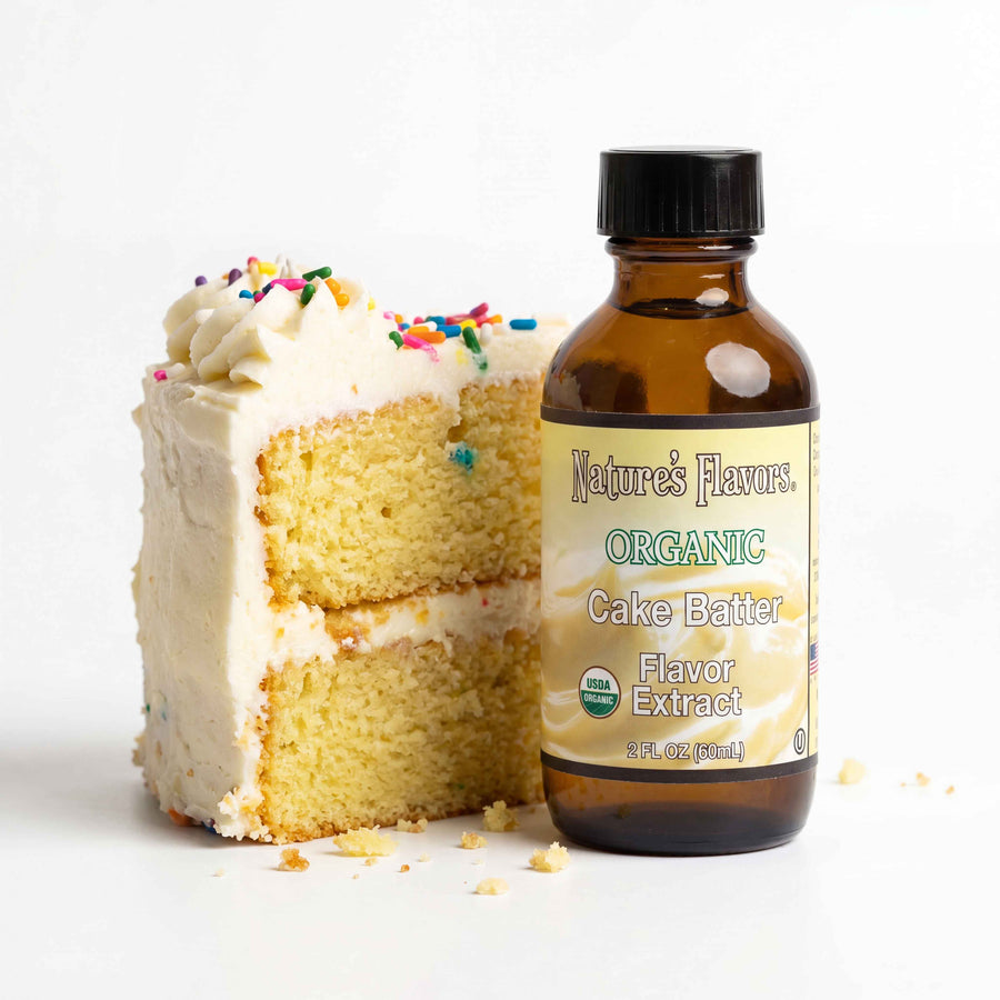bottle labeled, "Organic Cake Batter flavor extract" next to a slice of cake.