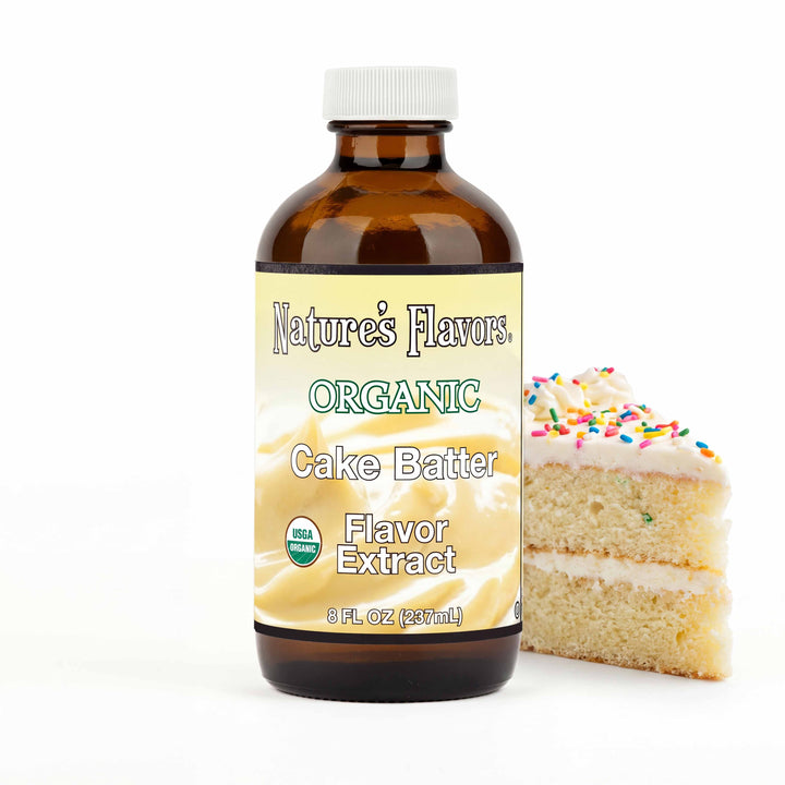bottle labeled, "Organic Cake Batter flavor extract" next to a slice of cake.
