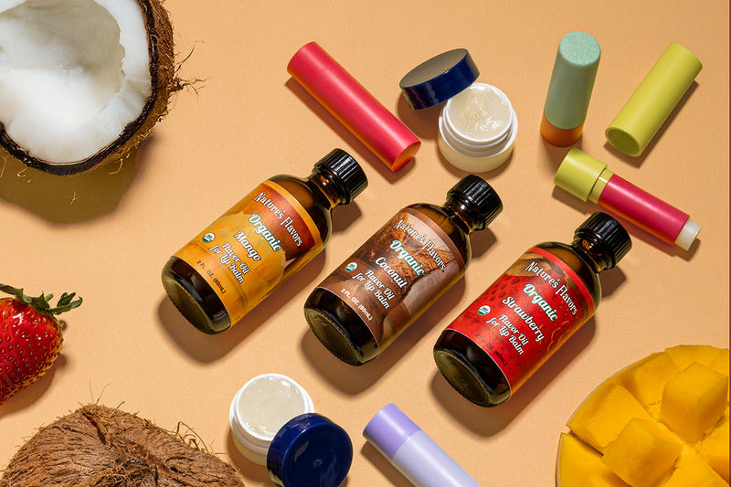 Collection of Nature's Flavors flavor oil for lip balm on a beige background with natural elements.
