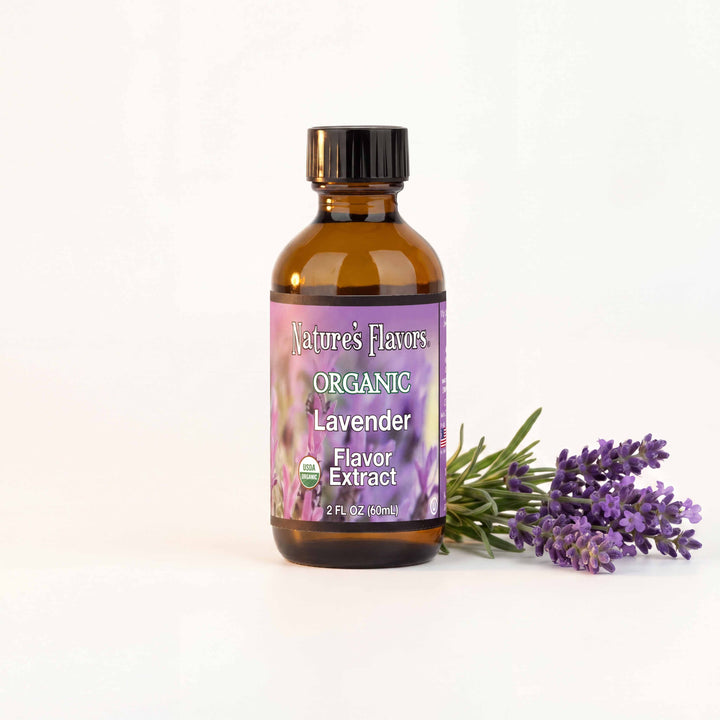Bottle labeled, "organic lavender flavor extract" next to a few lavender plants. 