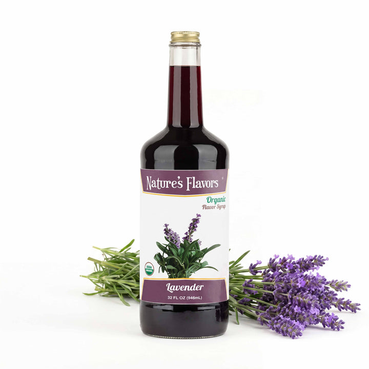 Bottle labeled, "Organic Flavor Syrup Lavender" next to a stack of lavender plants.