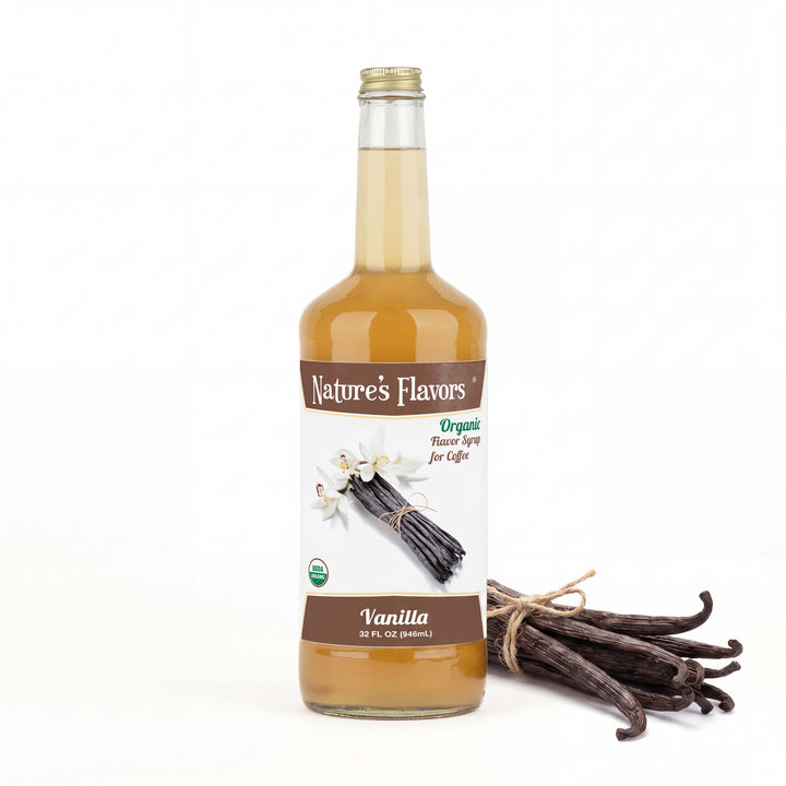Bottle labeled, "Organic Flavor Syrup for Coffee" with vanilla sticks and flowers next to it. 