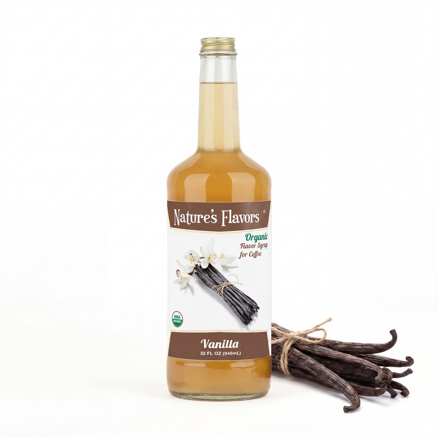 Bottle labeled, "Organic Flavor Syrup for Coffee" with vanilla sticks and flowers next to it. 