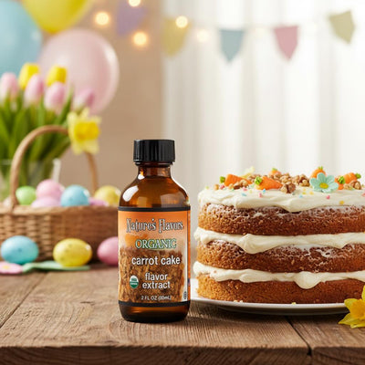 Bottle of Nature's Flavors Organic Carrot Cake flavor extract next to a carrot cake on a wooden table with Easter decorations in the background.