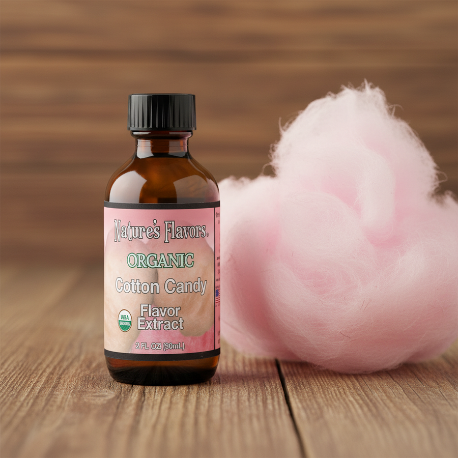 Bottle of Nature's Flavors Organic Cotton Candy Flavor Extract with cotton candy on a wooden surface
