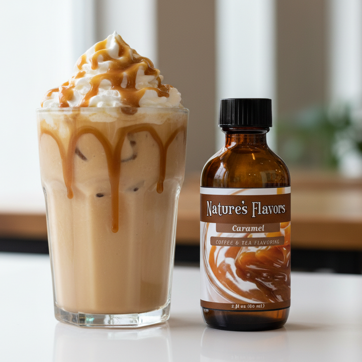 Glass of iced coffee with whipped cream and caramel drizzle next to a bottle of Nature's Flavors Caramel syrup.