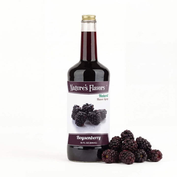 bottle labeled, "Natural Flavor Syrup Boysenberry" next to boysenberries. 
