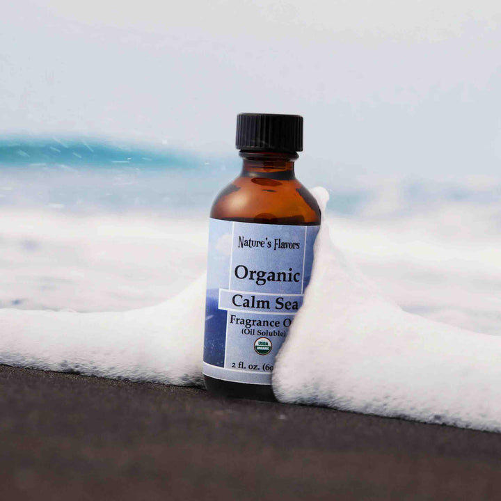 Bottle of Organic Calm Sea fragrance oil with a beach background