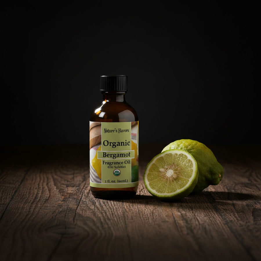 Bottle of Organic Bergamot Fragrance Oil with a sliced lime on a wooden surface