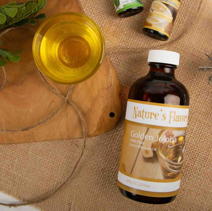 Nature's Flavors Golden Jojoba oil bottle on a rustic background