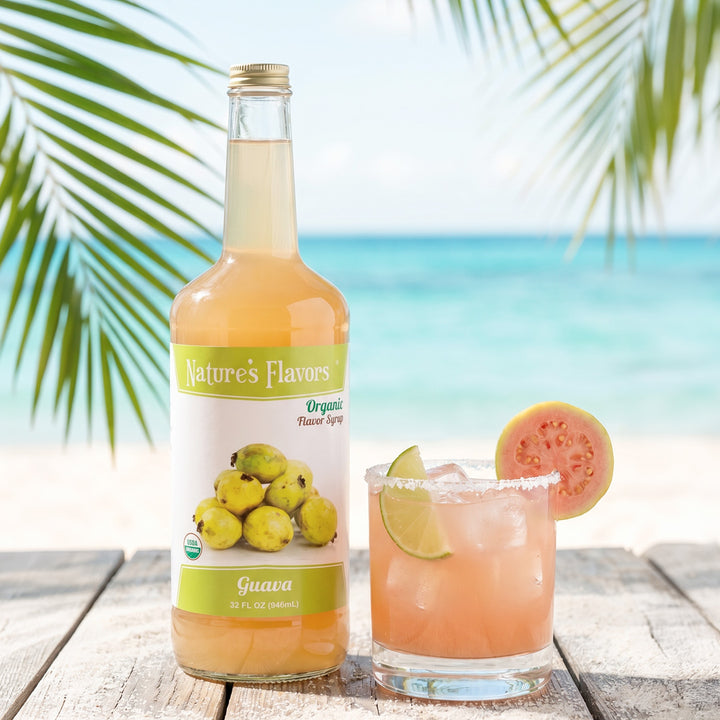 Bottle labeled, "Organic Flavor Syrup, Guava" next to a cocktail with a salted rim. 