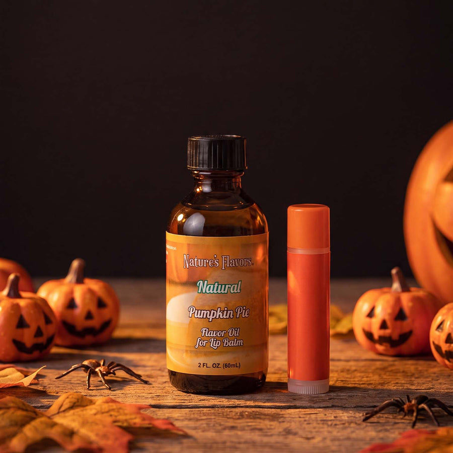 Bottle labeled, "Pumpkin Pie Flavor Oil for Lip Balm" next to an orange colored lip balm. 