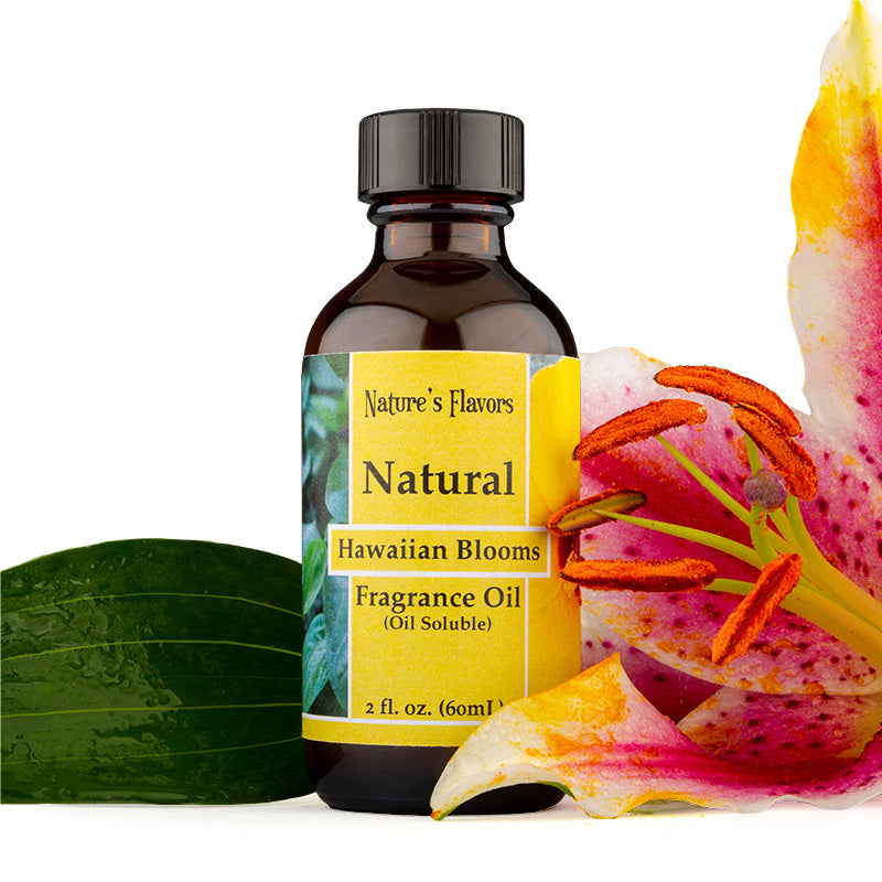 Bottle Labeled, "Natural Hawaiian Blooms Fragrance Oil (Oil Soluble)" next to flower petals. 