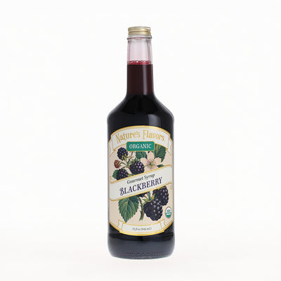 A bottle of Nature's Flavors Organic Gourmet Syrup in Blackberry flavor, featuring a cream-colored label with illustrations of blackberries and green leaves, set against a plain white background.