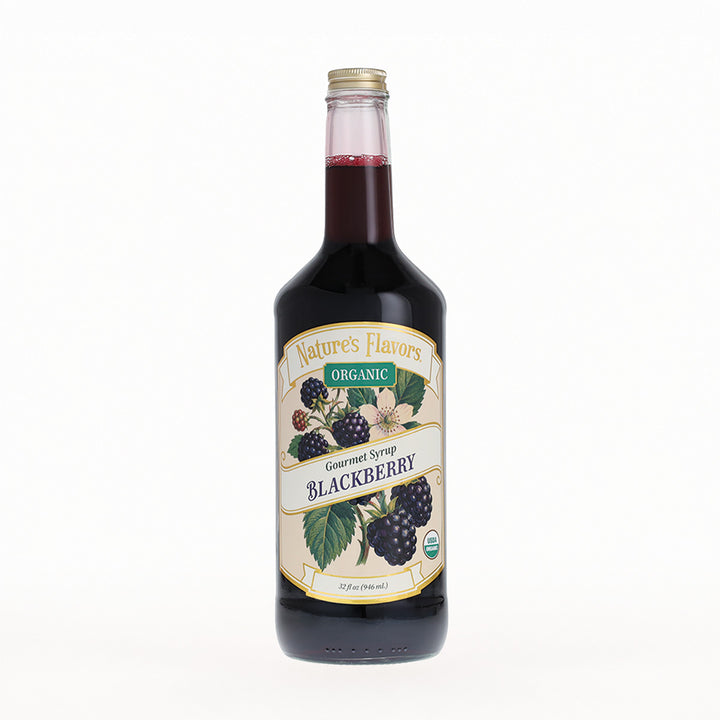 A bottle of Nature's Flavors Organic Gourmet Syrup in Blackberry flavor, featuring a cream-colored label with illustrations of blackberries and green leaves, set against a plain white background.