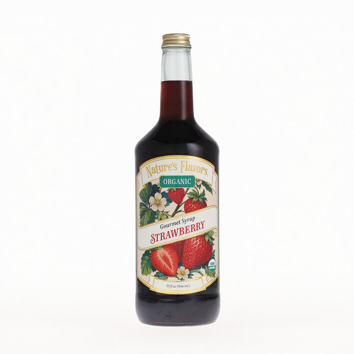 A bottle of Nature's Flavors Organic Gourmet Syrup Strawberry, featuring a dark red liquid in a clear glass bottle with a cream-colored label and a gold cap, set against a plain white background.