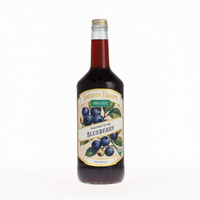 A bottle of Nature's Flavors Organic Gourmet Syrup Blueberry, filled with dark blueberry syrup, on a clean white background.