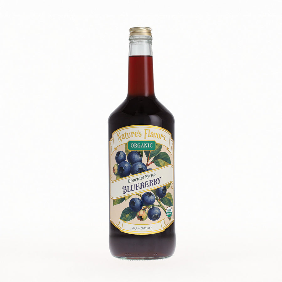 A bottle of Nature's Flavors Organic Gourmet Syrup Blueberry, filled with dark blueberry syrup, on a clean white background.
