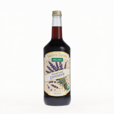 A bottle of Nature's Flavors Organic Gourmet Syrup, Lavender, in a clear glass bottle with a gold cap, set against a plain white background.