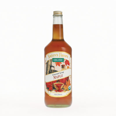 A glass bottle of Nature's Flavors Organic Gourmet Syrup Maple, filled with amber-colored syrup and featuring a vintage-style label with autumn leaves, set against a plain white background.