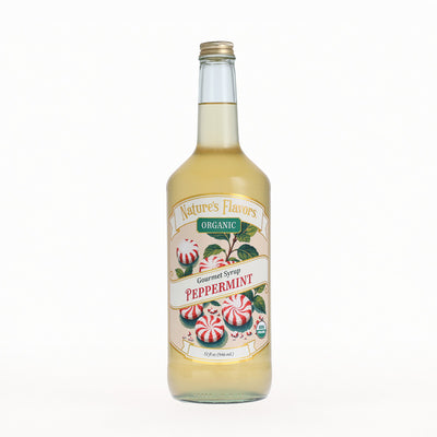 A bottle of Nature's Flavors Organic Gourmet Syrup Peppermint, filled with pale yellow liquid and featuring a festive label with peppermint candies, set against a plain white background.