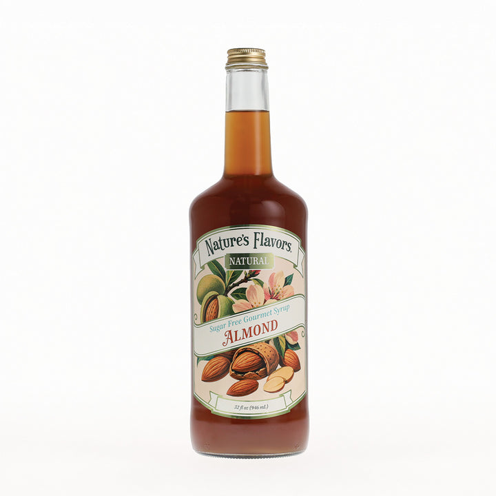 A bottle of Nature's Flavors Almond Syrup with a gold cap, filled with amber liquid, and featuring a cream-colored label with illustrations of almonds, set against a plain white background.