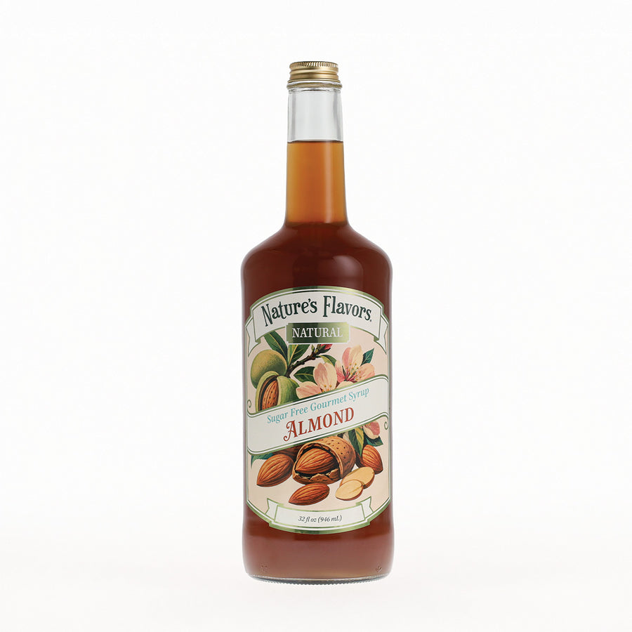 A bottle of Nature's Flavors Almond Syrup with a gold cap, filled with amber liquid, and featuring a cream-colored label with illustrations of almonds, set against a plain white background.