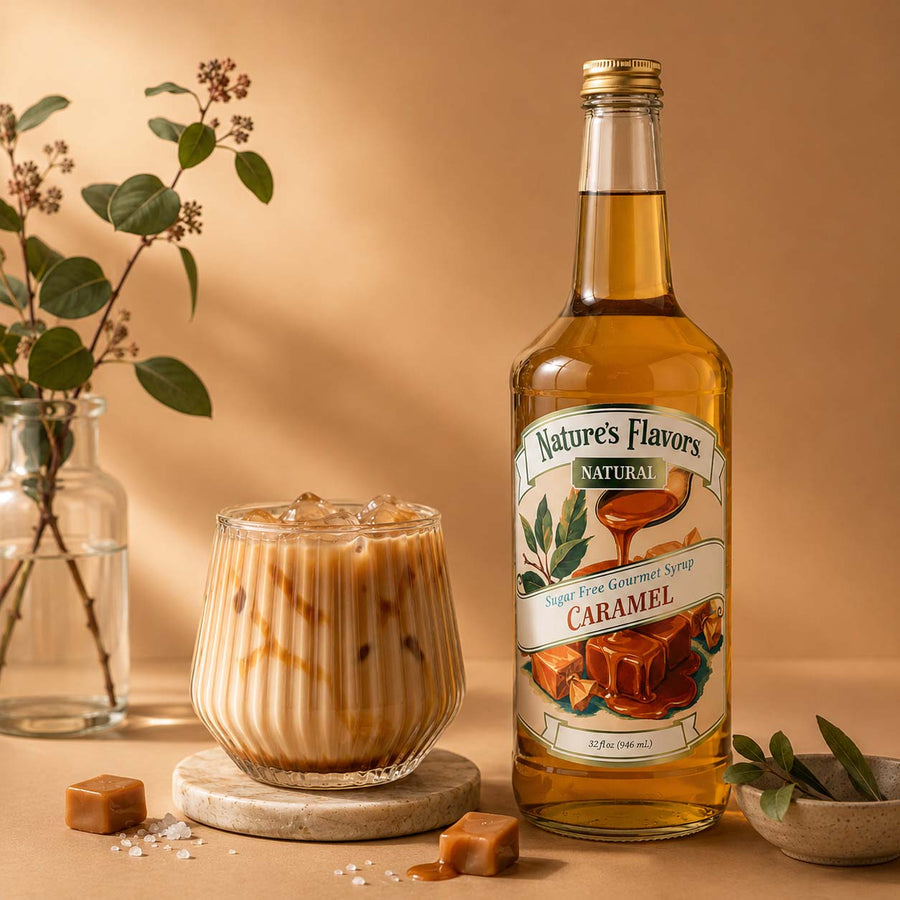 A bottle of Nature's Flavors Sugar Free Caramel Syrup stands next to a glass of iced caramel latte on a warm beige background with decorative leaves and caramel pieces.