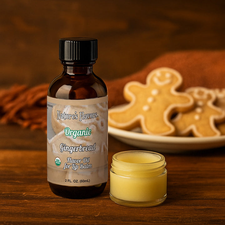 Nature's Flavors Organic Gingerbread lip balm bottle flavor oil and jar on a wooden surface with gingerbread cookies in the background.