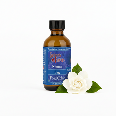 Bottle of Natures Flavors Natural Blue Food Color with a white flower on a white background