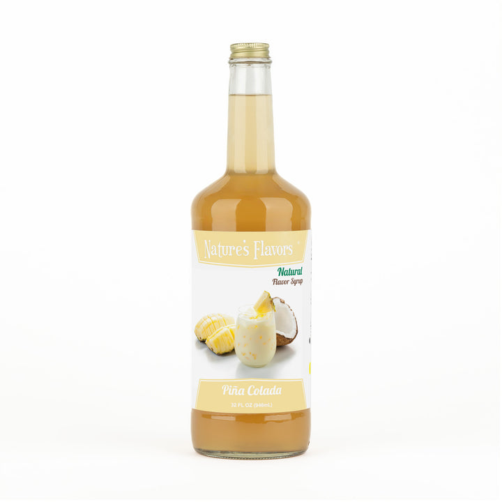A transparent bottle with orange liquid and a label on it that reads, “Natural Flavor Syrup Piña Colada. 32oz.”