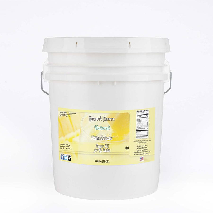 A white bucket with a label on it that reads "Piña Colada Flavor Oil for Lip Balm. 5 Gallon."
