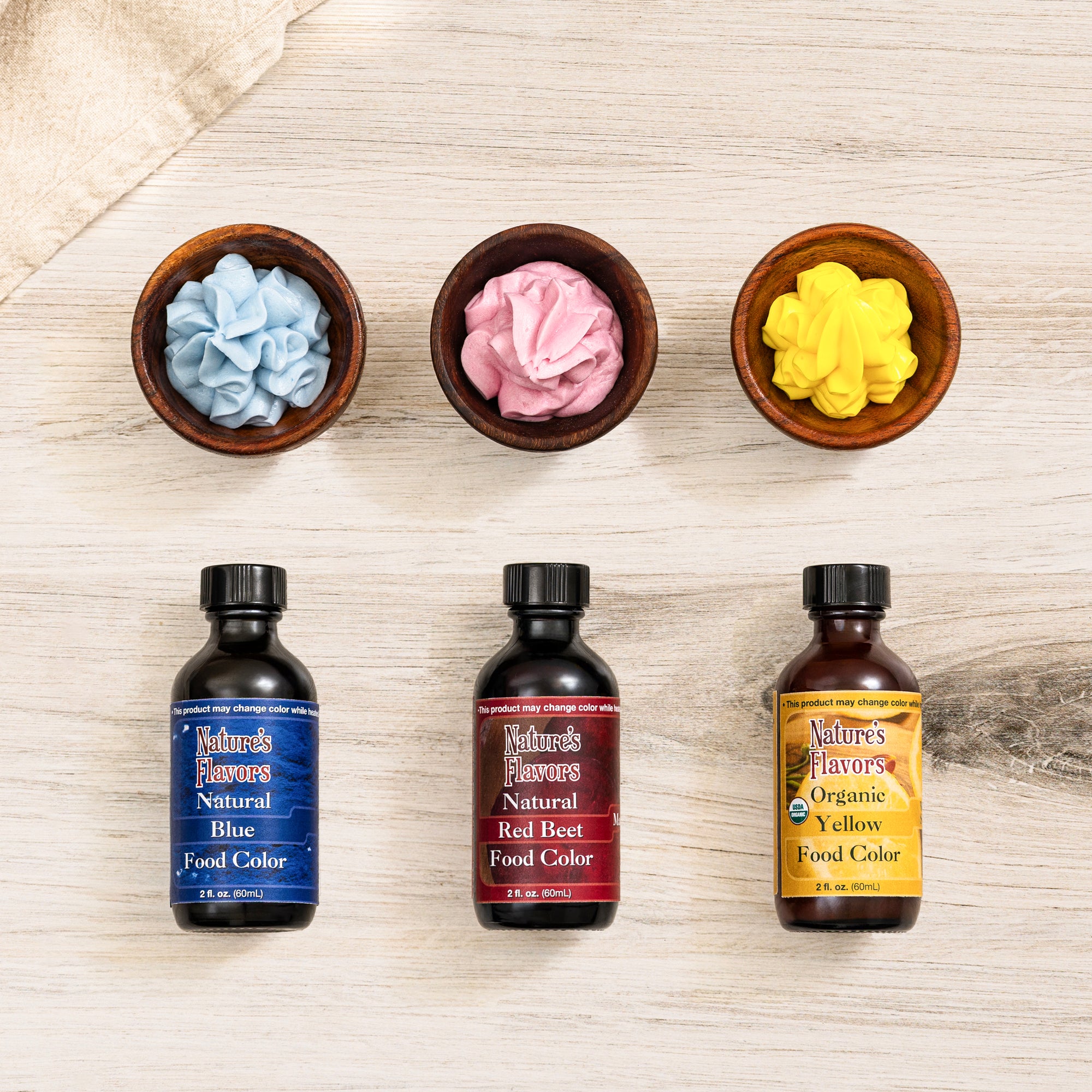 An array of differently colored natural food coloring in red, blue, and yellow.