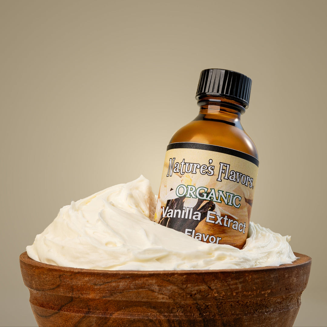 A bottle of organic vanilla extract placed in a bowl filled with light, airy whipped frosting, showcasing a delicious dessert setup.