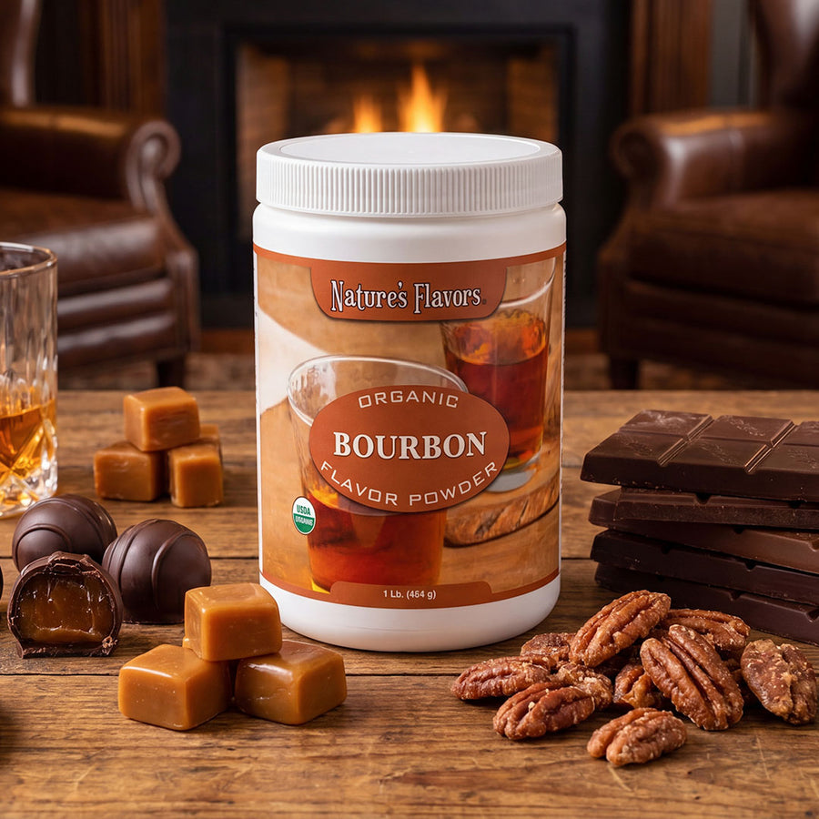 White tub labeled, "Organic Bourbon Flavor Powder" next to small chocolate candies and a glass of whisky.