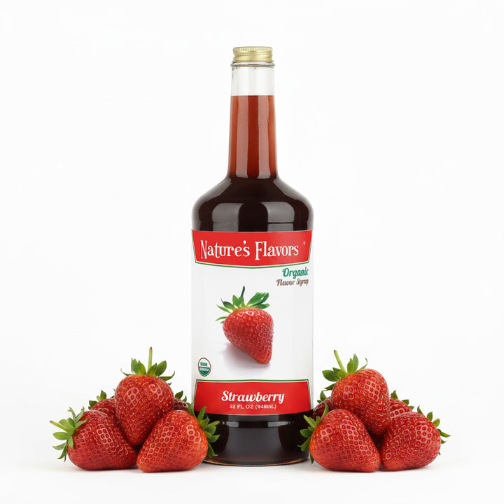 Bottle labeled, "Organic Flavor Syrup Strawberry" next to two bunches of strawberries. 