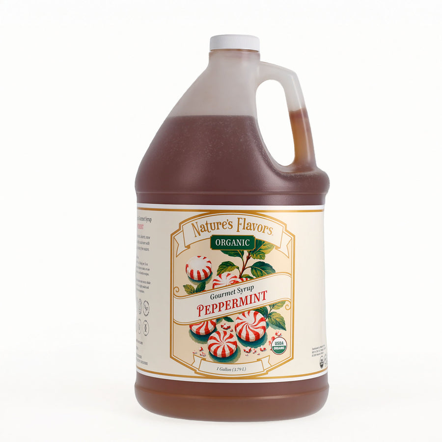 A one-gallon plastic jug of Nature's Flavors Organic Gourmet Syrup Peppermint, filled with dark brown syrup and featuring a cream-colored label with red and green peppermint illustrations.