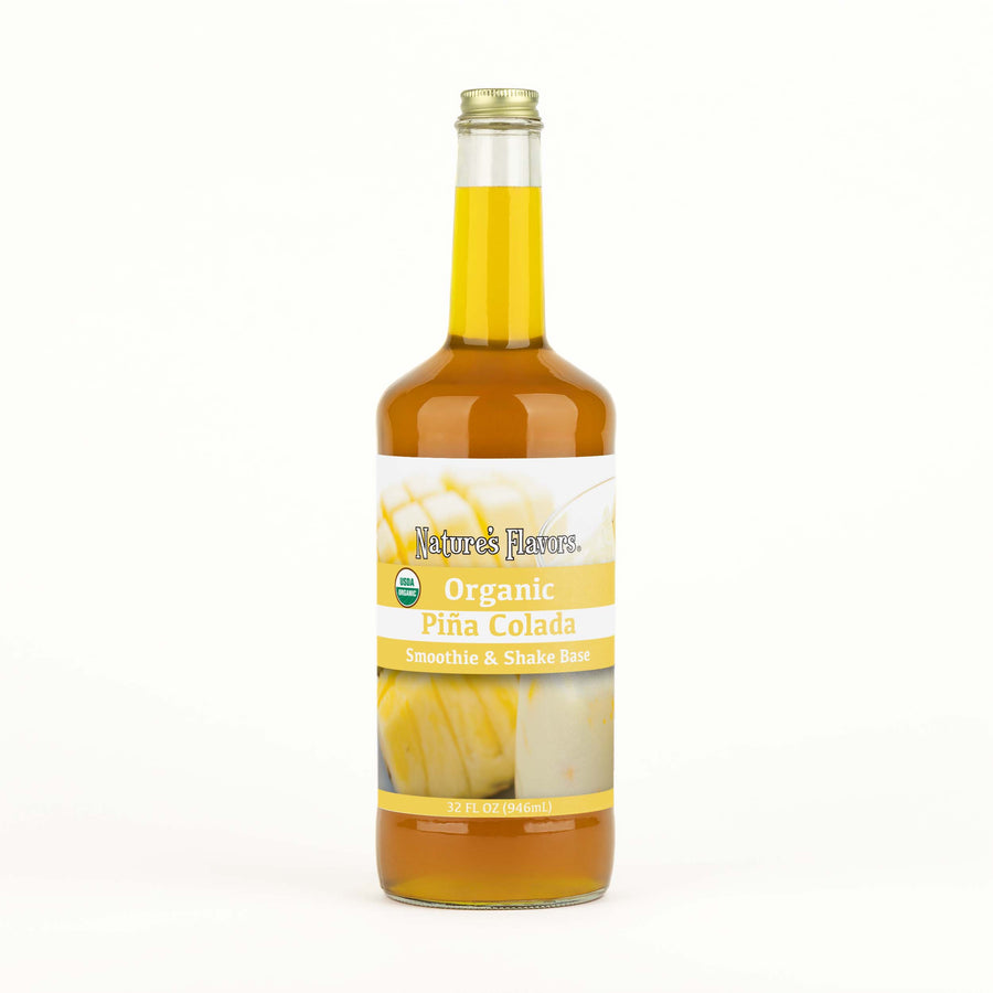 A transparent bottle with orange liquid and a label on it that reads, “Organic Piña Colada Smoothie & Shake Base. 32oz.”
