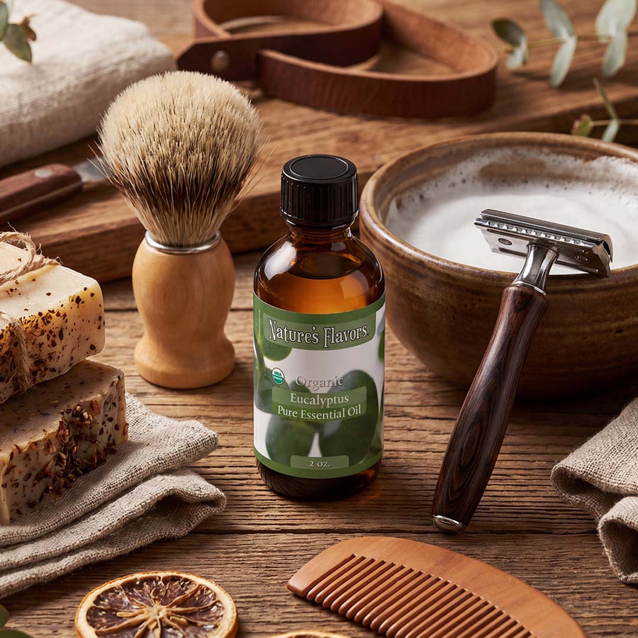 Bottle labeled, "Organic Eucalyptus Pure Essential Oil" next to shaving supplies for men. 