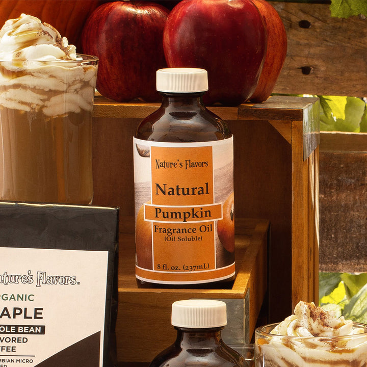 Bottle labeled, "Natural Pumpkin Fragrance Oil (Oil Soluble)" next to autumn seasonal items. 