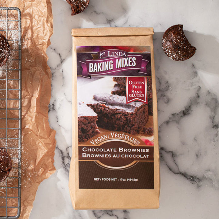 Package labeled, "gluten free vegan chocolate brownies" next to a few bakes brownies. 