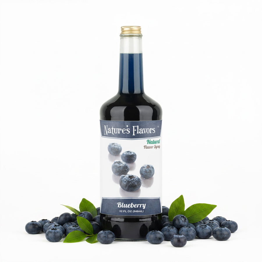 bottle labeled, "Natural Flavor Syrup Blueberry" next to a group of blueberries 