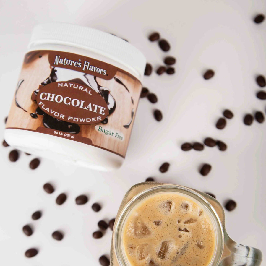 Nature's Flavors chocolate flavor powder container with a glass of iced coffee and scattered coffee beans.