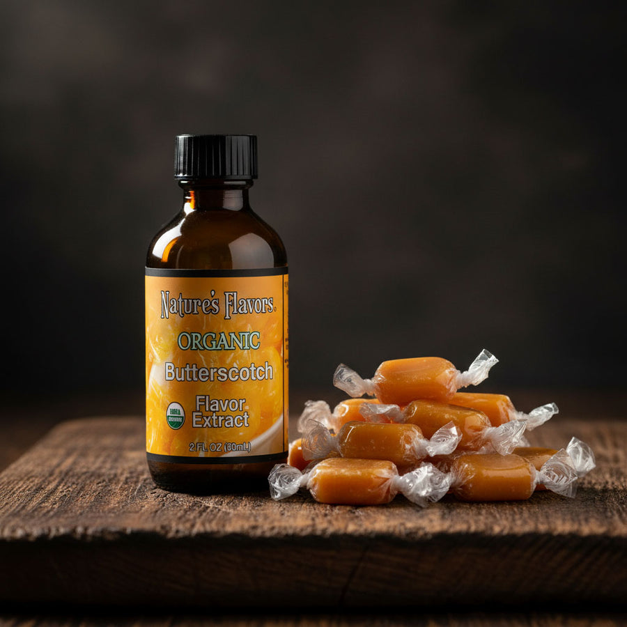 bottle labeled, "organic Butterscotch flavor extract", next to caramel colored candies in wrappers. 