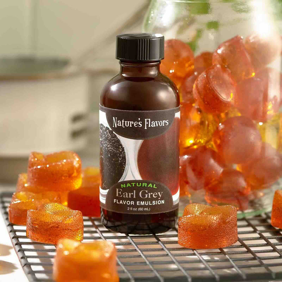 Bottle of Nature's Flavors Natural Earl Grey flavor emulsion with gummy bears on a cooling rack.