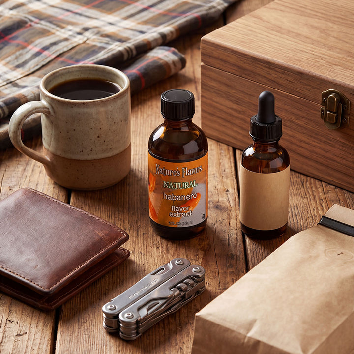 Bottle labeled, "Natural Habanero flavor extract" next to an assortment of fathers day gifts. 