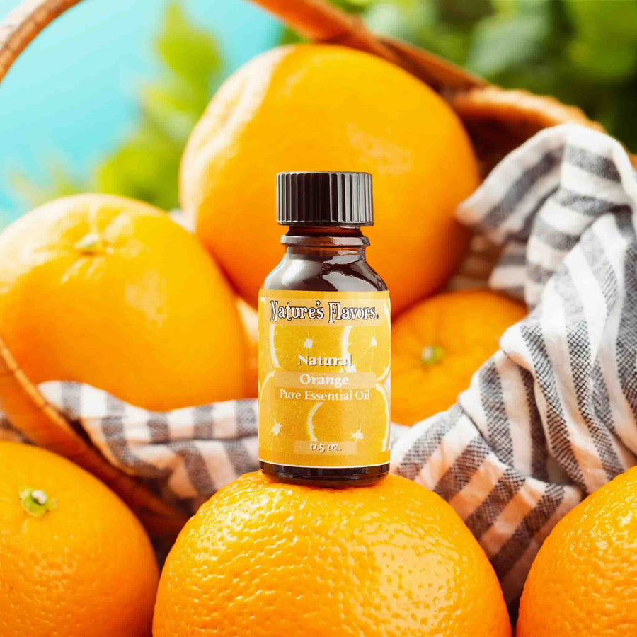 Bottle of Nature's Flavors Natural Orange Pure Essential Oil on oranges with a basket in the background
