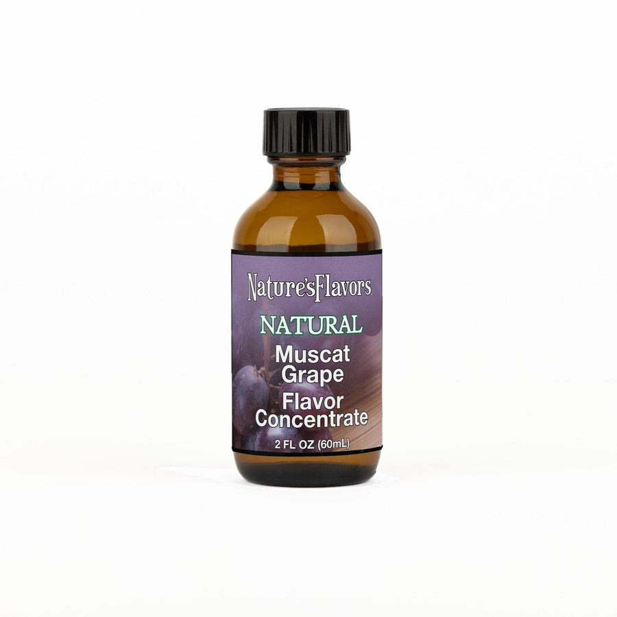A 2 fl oz amber glass bottle of Nature's Flavors Muscat Grape Flavor Concentrate, Natural with a black cap, centered on a white background.
