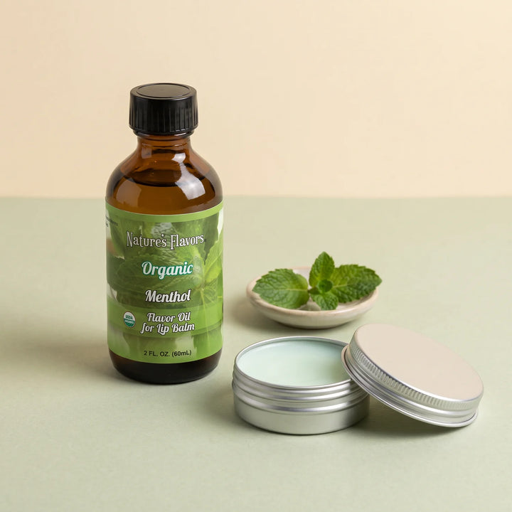 Nature's Flavors Organic Menthol Flavor Oil for Lip Balm, 2 oz bottle with mint flavor cues and an open unbranded lip balm tin.